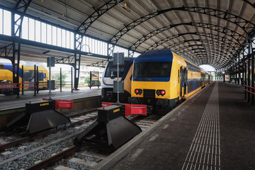 Trains awaiting departure along the platform in the famous Haarlem train station