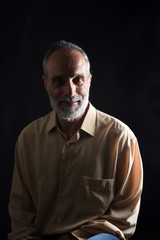 Fototapeta premium portrait of a middle aged man on black