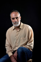 Fototapeta premium portrait of a middle aged man on black