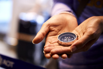 compass in a woman's hand © 1981 Rustic Studio