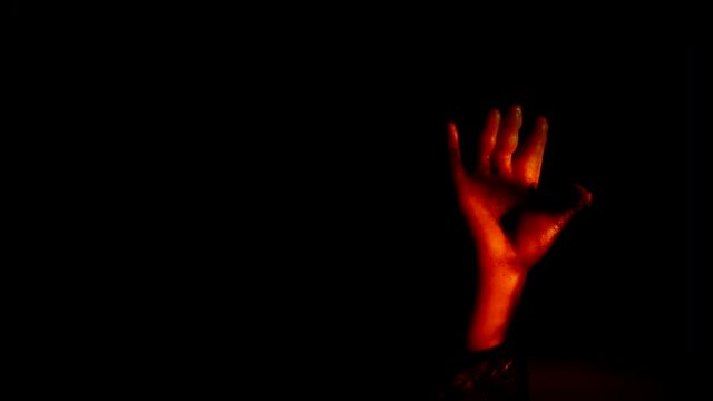 BABY DOLL HAND REACHES UPWARD FROM THE DARKNESS, IN 4K
