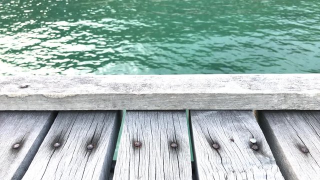The texture of old wooden bridge and beautiful wave background.