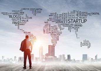 Motivation and inspiration concept with modern cityscape and businessman observing it