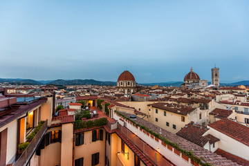 Obraz premium Firenze, Florence, Italy historic city with church duomo famous dome architecture, summer evening sunset night cityscape skyline, mountain aerial view of urban rooftops