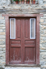 Old wooden entrance door of a stone house