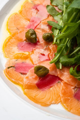Tuna and salmon carpaccio with tarragon, capers and lemon.