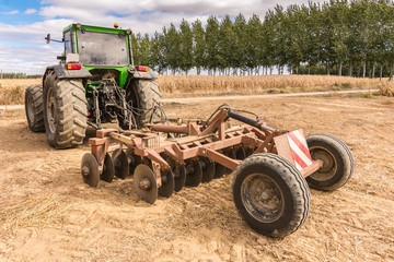 Tractor with a plow to start the daily work of a farmer