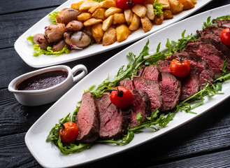 Chateaubriand steak. Served with fried potatoes, champignons, cherry tomatoes and Spanish sauce
