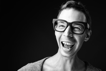 Rebellious man against black background in black and white