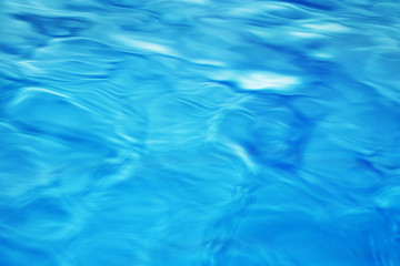 The smooth natural blue water background with bokeh  abstract on the sea or ocean,vintage and soft colored blur.