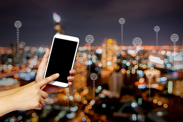 Connection and technology concept, holding phone and press on screen on night city background