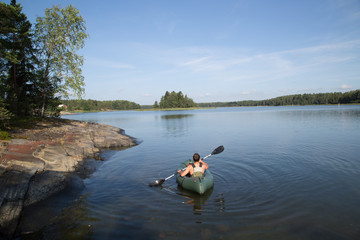 Fototapeta na wymiar Packraft paddler in the archipelago Tammisaari