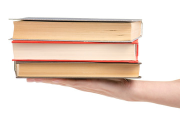 Stack of books in hand on a white background isolation