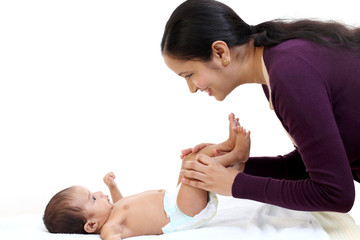 Cheerful mother playing with newborn baby - 227974309