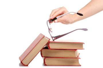 Books and glasses for vision in hand on a white background. Isolation.