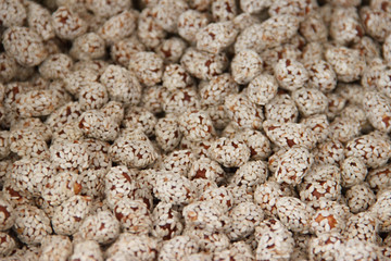 peanuts in caramel covered sesame background texture