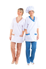 two young women in cook costumes isolated on white background in full growth look into camera