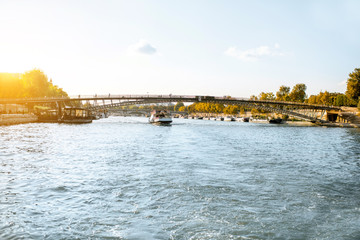Fototapeta premium Landscape view on the riverside from the boat sailing on Seine river during the sunset in Paris