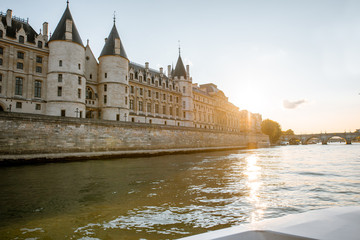 Obraz na płótnie Canvas Landscape view on the riverside from the boat sailing on Seine river during the sunset in Paris