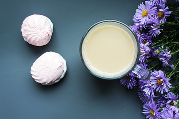 White apple marshmallow flowers on white plate with cup of coffe. Beautifully decorated dessert. Copy space for text.