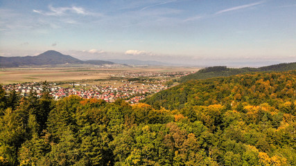 Aerial view of beautiful Transylvania. Carpathian mountains in autumn, sunset with beautiful collors and clouds.