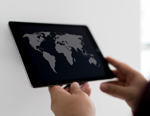 Map of world on smart device in hands