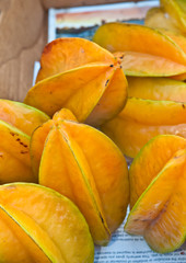 Top view, close up of freshly picked star fruits on display and for sale at a tropical, autumn, farmers market