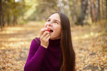 Charming girl with a red apple.