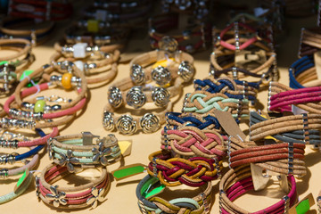 Fototapeta na wymiar Handmade leather bracelets. Street market souvenirs, wristbands, costume jewelry concepts