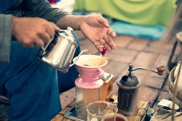 Barista making drift hot coffee in day market.