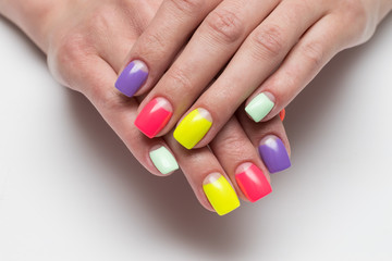 Bright summer rainbow moon manicure in red, yellow, mint, lilac, pink shades on square nails on a white background close-up
