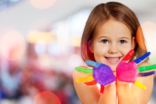 Cute little girl with colorful painted hands