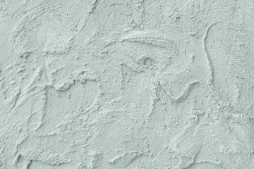 Relief stucco on the wall. Mint color. Close up