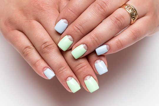 Summer pastel moon manicure in mint blue tone on short square nails on a white background close-up
