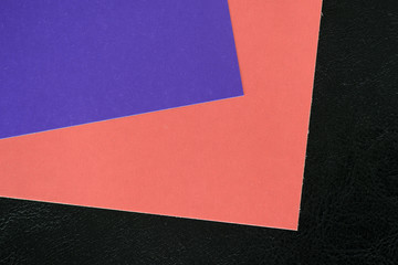 Colorful sheets of paper on a dark background close up