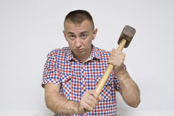 Dissatisfied man with a sledgehammer on a white background. Work concept