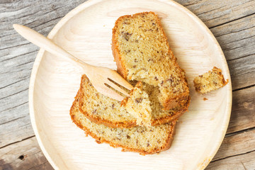Banana cake on wood plate. Over wooden table.Top view with copy space.