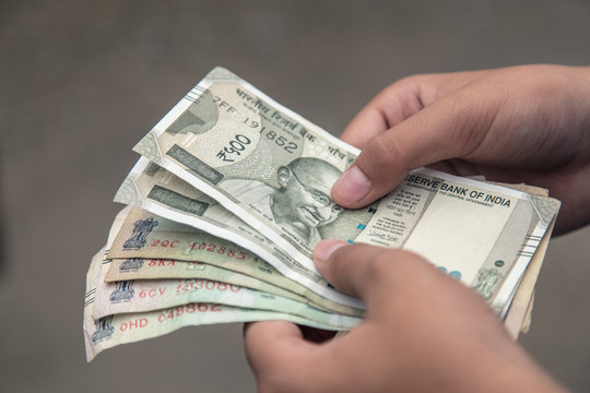 Close up of hand counting Indian rupee notes India