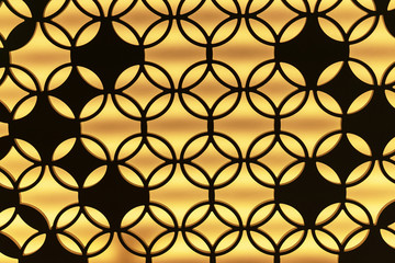 The contour of a metal lattice with an ornament on a yellow background.