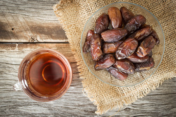 Dried date fruit served with hot tea. Top view.  High nutrition fruit. Arabic favorite fruit.