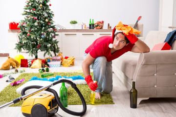 Man cleaning his apartment after christmas party
