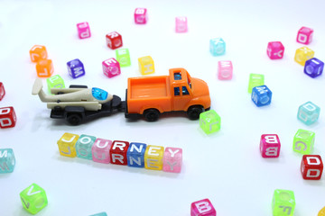 toy truck with journey word and beads pulling a glider