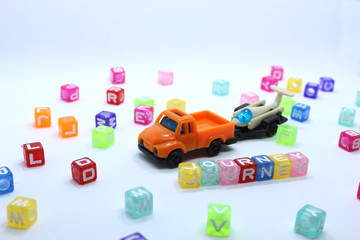 toy truck with journey word and beads pulling a glider