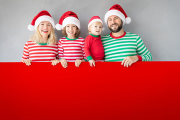 Family holding cardboard banner blank