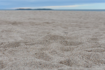 White sand with blue sky background.