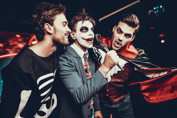 Young Men in Halloween Costumes Singing Karaoke
