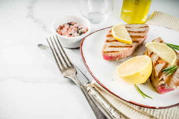 Grilled tuna fish steaks with lemon and spices