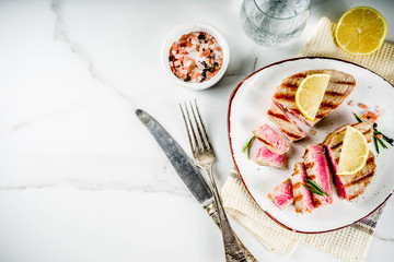 Grilled tuna fish steaks with lemon and spices