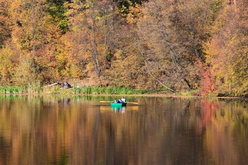 Ukraine. Kyiv. Pushcha Voditsa. Autumn. The people enjoying the boating in the lake in autumn.