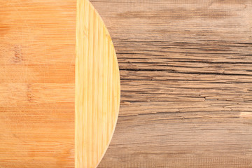 Empty cutting board on a dark wooden table. Top view
